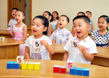 Children studying in a kindergarten under the 12 year universal compulsory and free education system