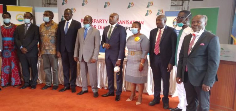 NRM SG Lumumba (3R) pose for a group photo with other Political Party leaders at IPOD Council meeting.