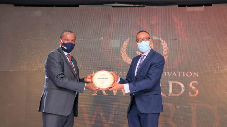 Latmar Mukasa the chairman Uganda Insurers Association handing over an award to one of the winners.