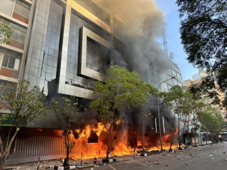 JUST IN: Kenyan Protesters Destroy And Burn Uganda House In Nairobi